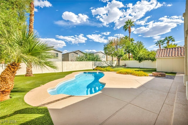 view of swimming pool featuring a lawn and a patio area