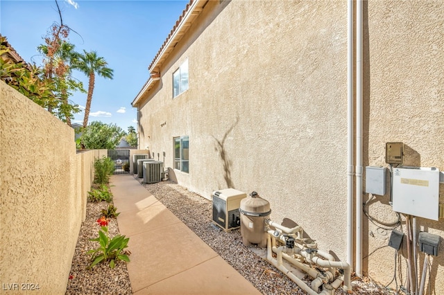 view of side of home with central AC