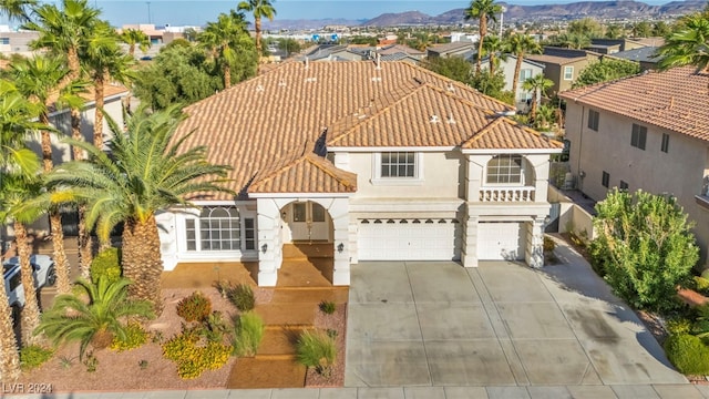 mediterranean / spanish house featuring a garage and a mountain view