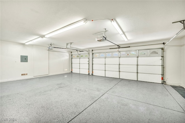 garage with a garage door opener and electric panel