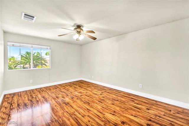 unfurnished room with hardwood / wood-style flooring and ceiling fan