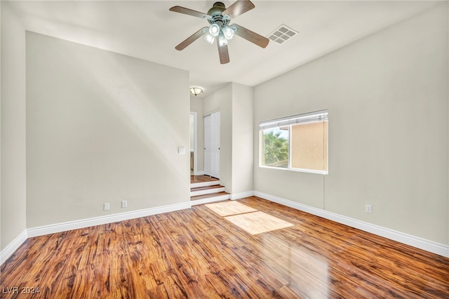 empty room with ceiling fan and wood-type flooring