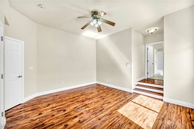 empty room with hardwood / wood-style flooring and ceiling fan