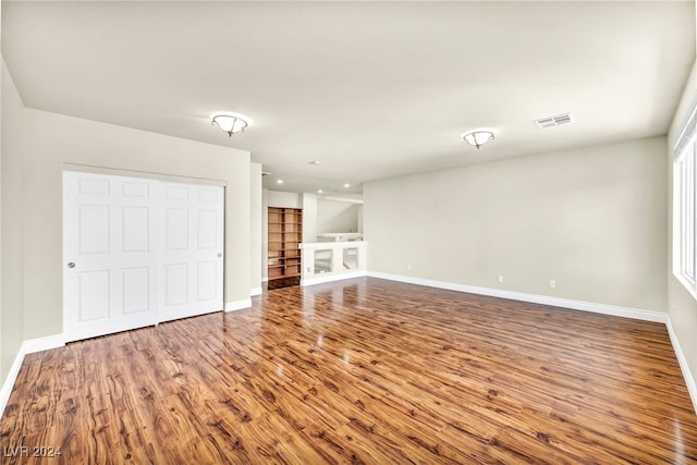 unfurnished living room featuring wood-type flooring