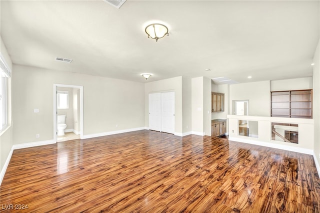 unfurnished living room with hardwood / wood-style flooring