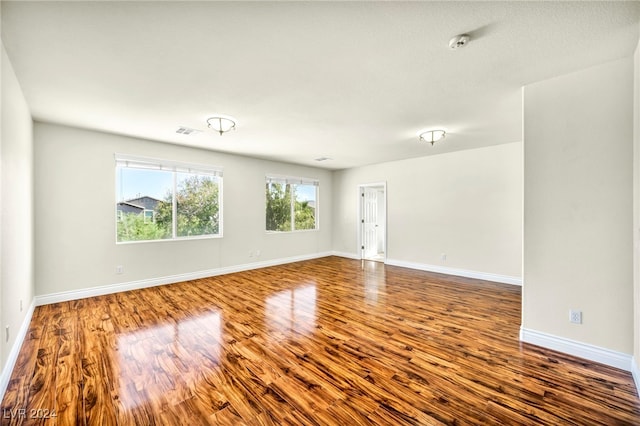 unfurnished room featuring hardwood / wood-style flooring