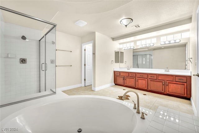 bathroom featuring vanity, tile patterned flooring, and plus walk in shower