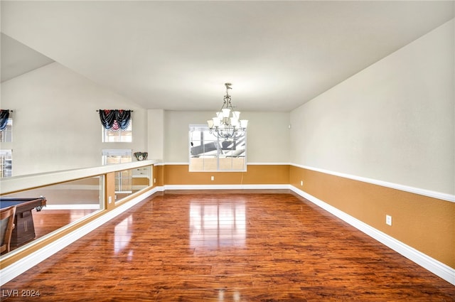 unfurnished dining area featuring wood-type flooring and a chandelier