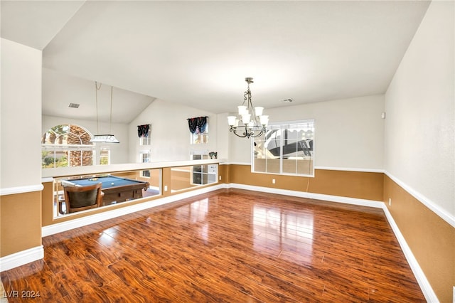 unfurnished dining area featuring lofted ceiling, hardwood / wood-style floors, a notable chandelier, and pool table