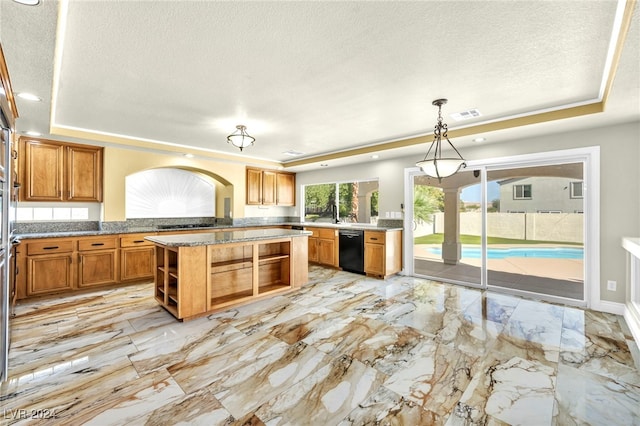 kitchen featuring decorative light fixtures, kitchen peninsula, a raised ceiling, and dishwasher