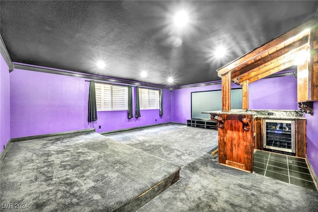 carpeted home theater room with wine cooler, a baseboard heating unit, crown molding, and indoor bar