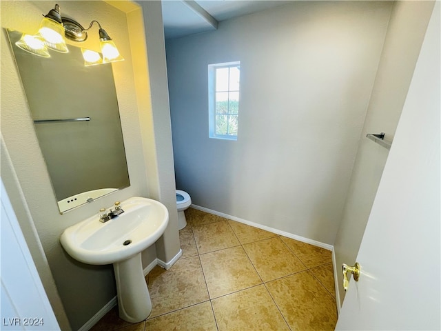 bathroom with tile patterned flooring and toilet