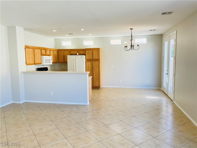 kitchen featuring kitchen peninsula, white appliances, pendant lighting, light tile patterned floors, and a notable chandelier