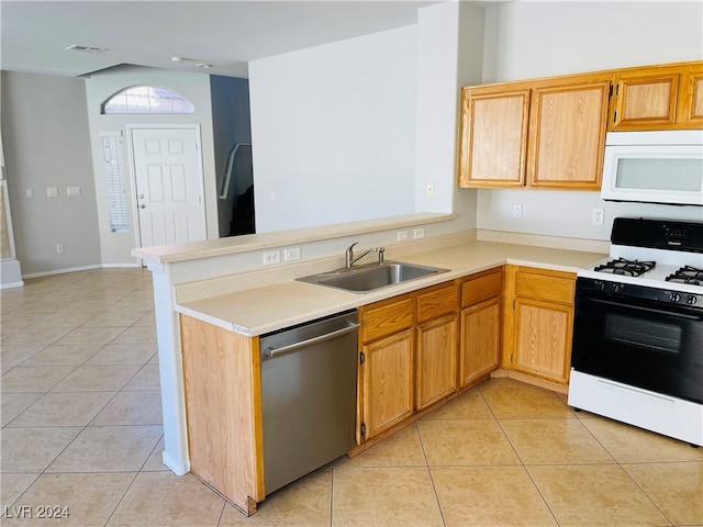 kitchen featuring kitchen peninsula, sink, light tile patterned floors, and white appliances