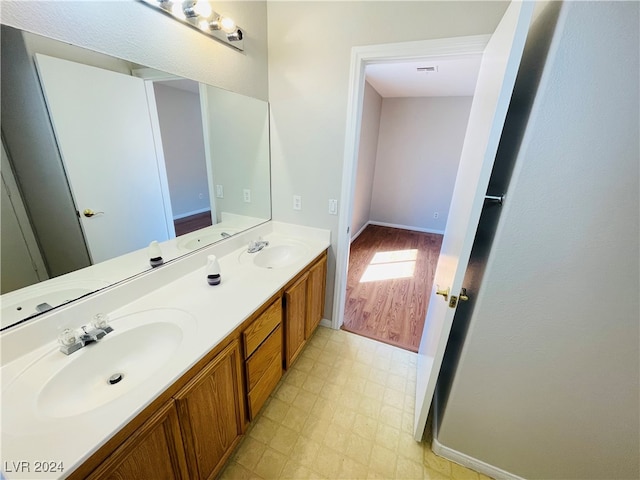 bathroom with hardwood / wood-style floors and vanity