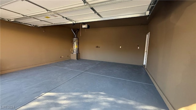 garage with water heater and a garage door opener