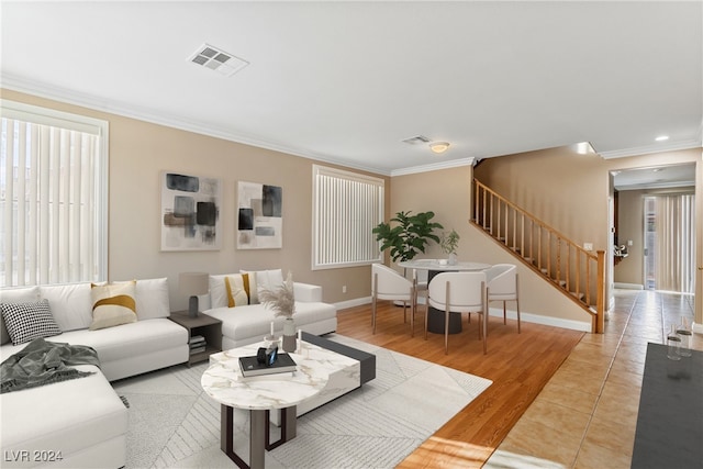 living room with crown molding and light hardwood / wood-style flooring