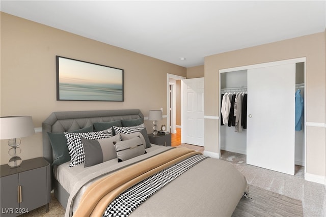 bedroom featuring a closet and light colored carpet