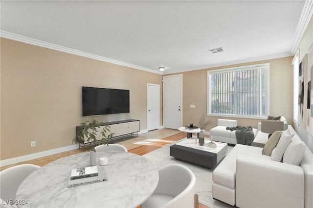 living room with crown molding and light hardwood / wood-style floors