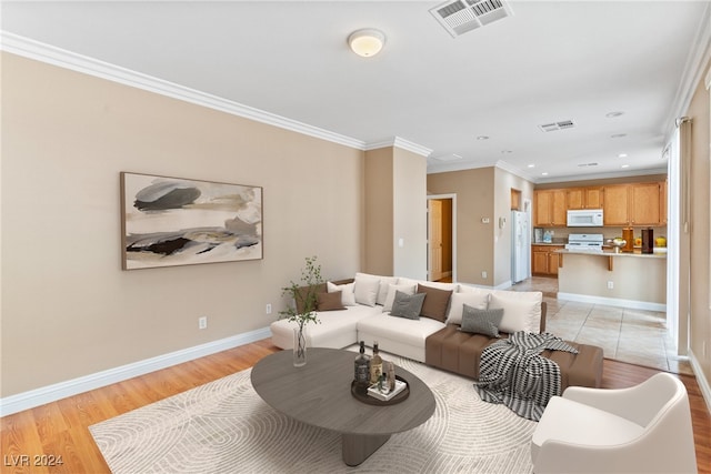 living room with light hardwood / wood-style floors and crown molding