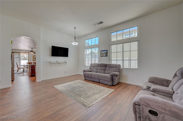 living room featuring ceiling fan and light hardwood / wood-style floors