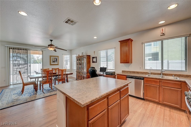 kitchen featuring a center island, ceiling fan, stainless steel appliances, and a wealth of natural light