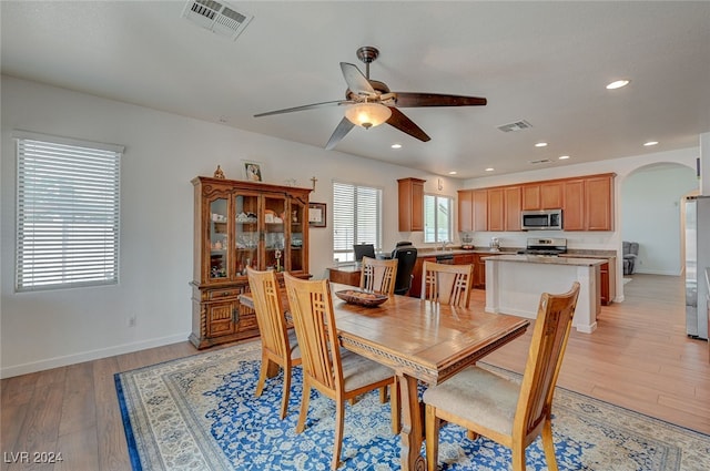 dining room featuring light hardwood / wood-style floors, ceiling fan, and sink