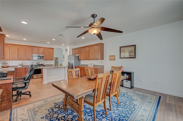 dining space with ceiling fan and light hardwood / wood-style floors