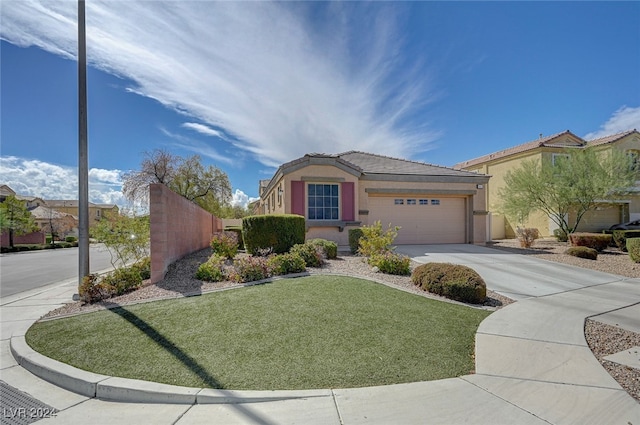 view of front of house featuring a front lawn and a garage