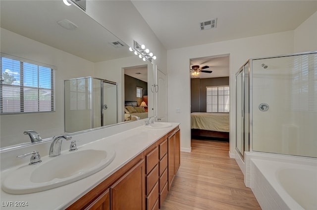 bathroom featuring ceiling fan, independent shower and bath, hardwood / wood-style flooring, and vanity