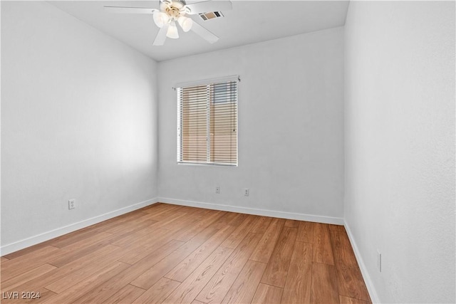 empty room featuring visible vents, light wood-style flooring, baseboards, and ceiling fan