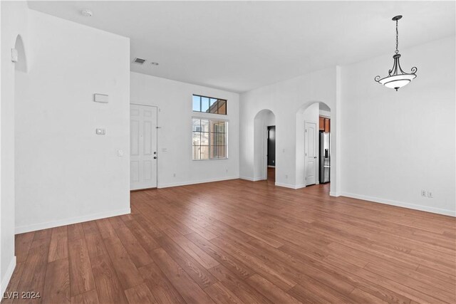 unfurnished living room featuring hardwood / wood-style floors