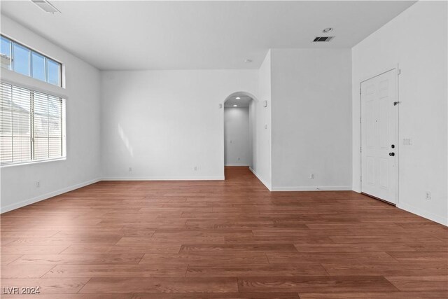 unfurnished room featuring hardwood / wood-style flooring