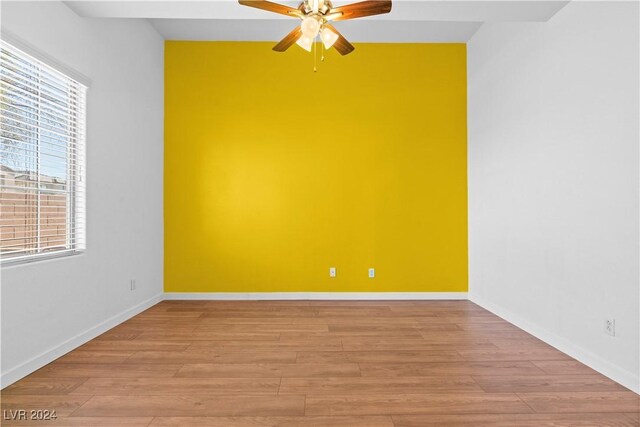 unfurnished room with ceiling fan and light hardwood / wood-style flooring