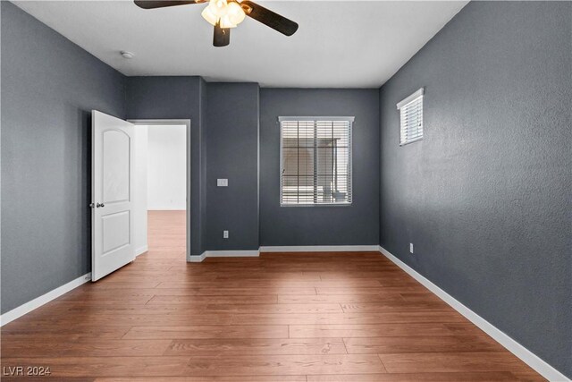 spare room with hardwood / wood-style flooring and ceiling fan