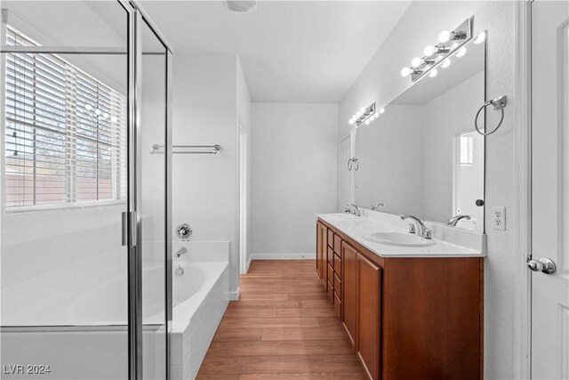 bathroom featuring vanity, separate shower and tub, and hardwood / wood-style floors