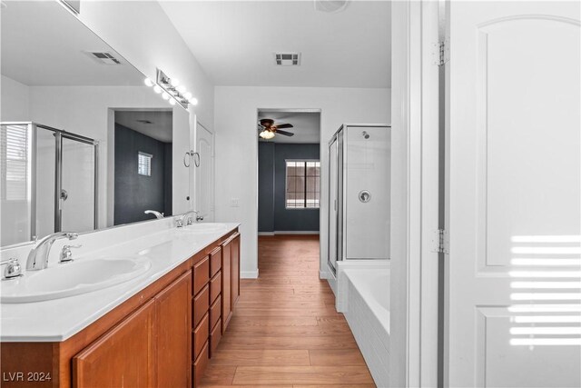 bathroom with vanity, wood-type flooring, shower with separate bathtub, and ceiling fan