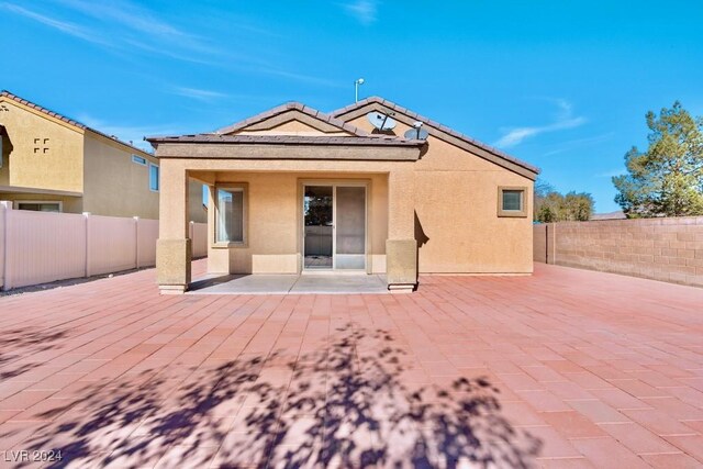 back of property featuring a patio