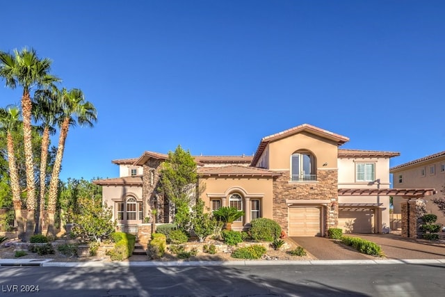 mediterranean / spanish-style home with a garage