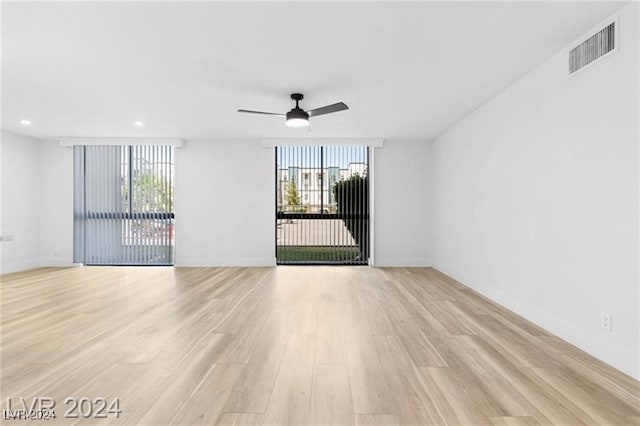 unfurnished room featuring ceiling fan and light hardwood / wood-style floors