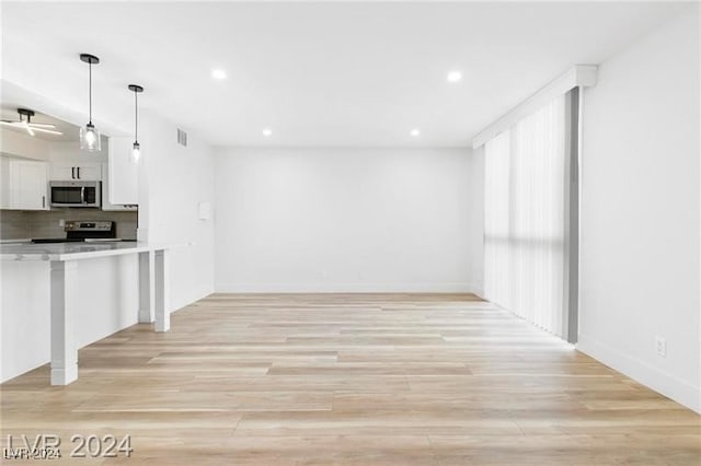 unfurnished living room featuring light wood-type flooring