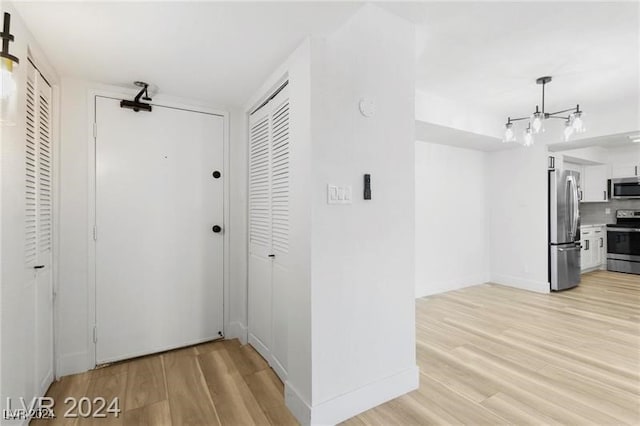 corridor with light hardwood / wood-style floors