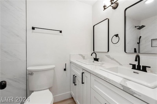 bathroom featuring toilet, vanity, and hardwood / wood-style flooring