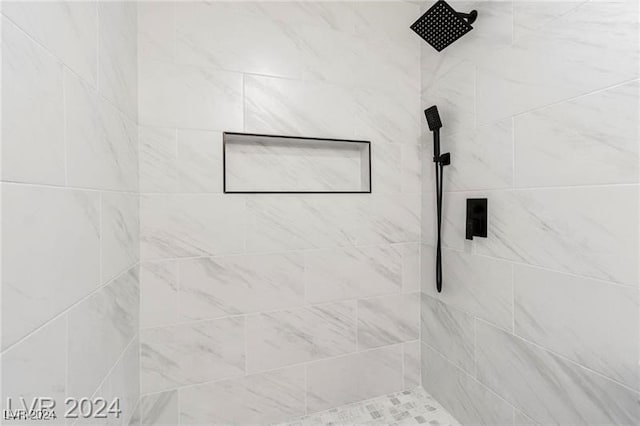 bathroom with a tile shower