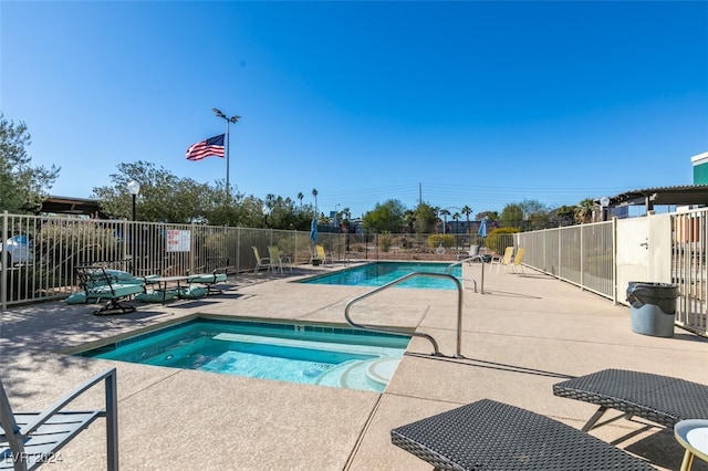 view of swimming pool featuring a patio and a community hot tub