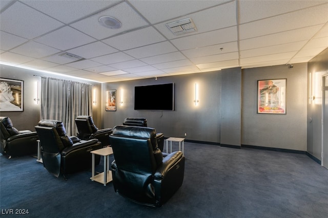 carpeted cinema featuring a drop ceiling