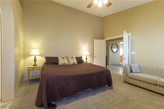 bedroom with carpet floors, a high ceiling, and ceiling fan