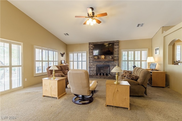 living room featuring a fireplace, vaulted ceiling, light carpet, and ceiling fan