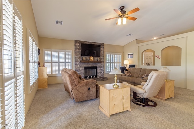 living room with ceiling fan, light colored carpet, plenty of natural light, and a fireplace