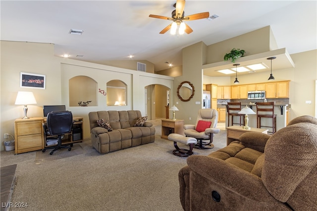 carpeted living room featuring ceiling fan and vaulted ceiling